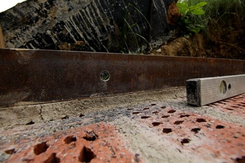 Die Arme schmerzen, der Bohrer ist stumpf und der Stahlträger hat sich natürlich vom Mörtelbett gelöst. Aber das Loch passt. 